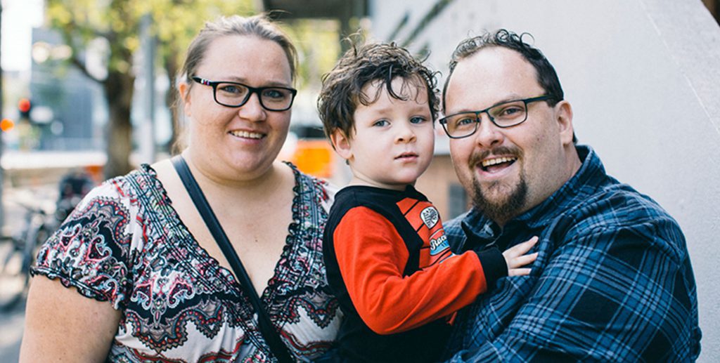 image of family of 3, two parents and a toddler