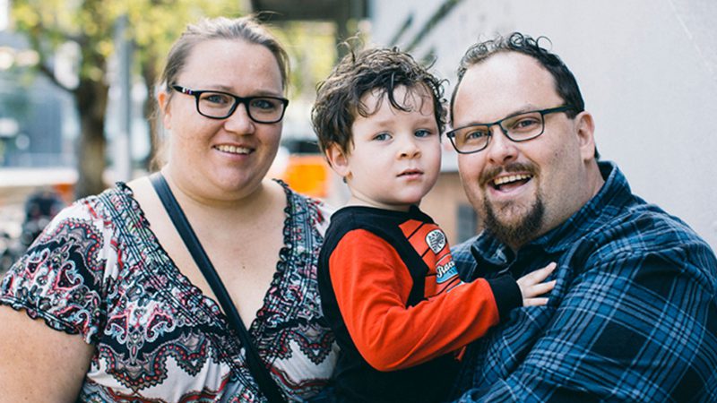 image of family of 3, two parents and a toddler