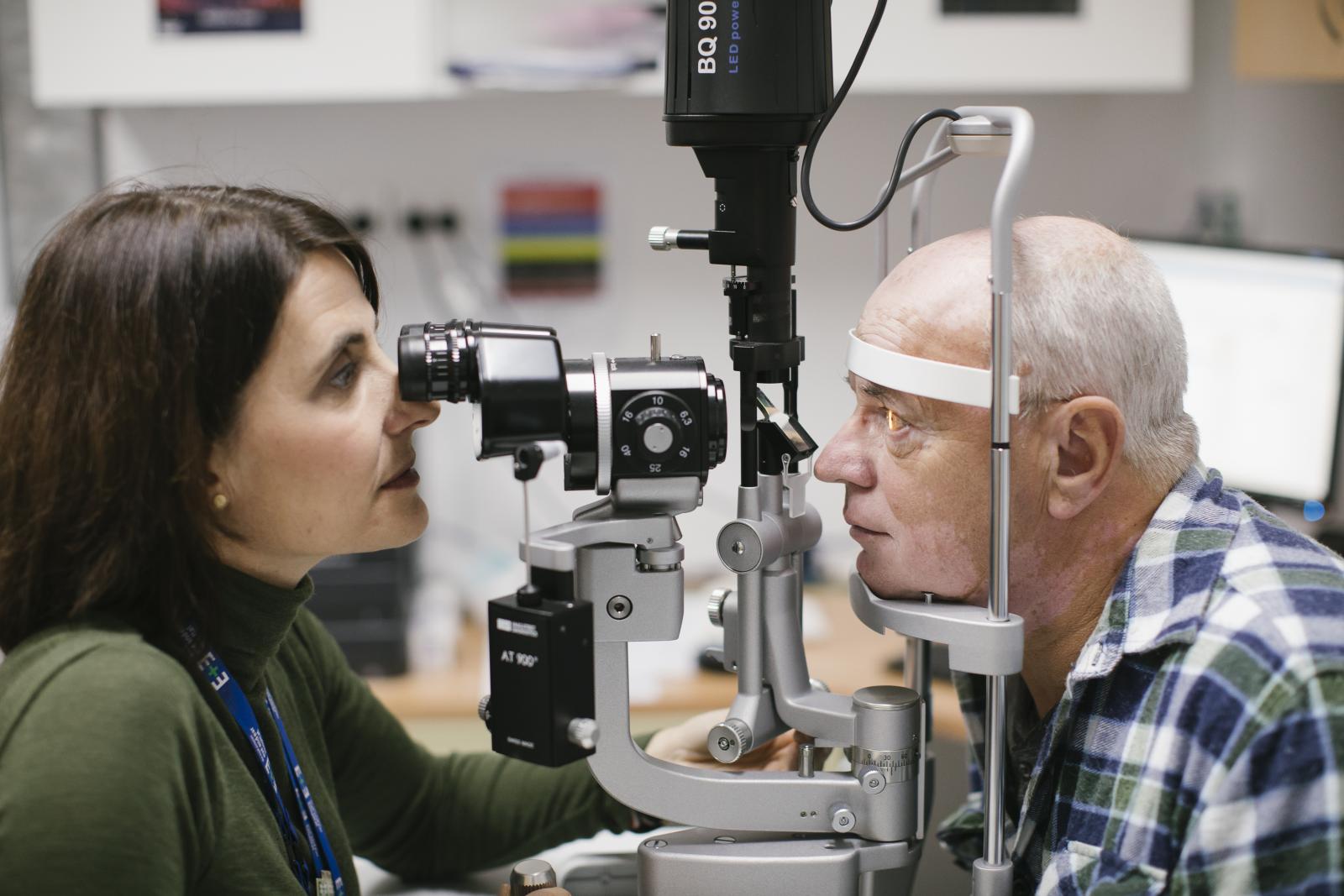 Orthoptist testing a patients eye