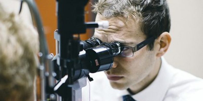 Clinician examining a patients eyes