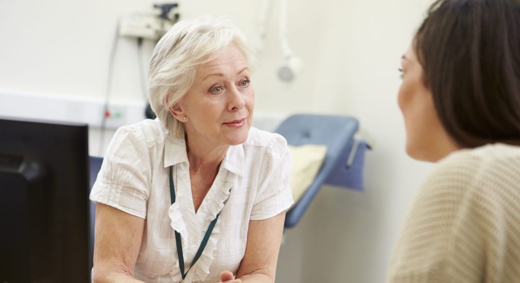 A clinician meeting with a patient