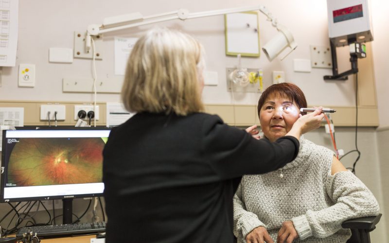 Clinician examining a patients eyes