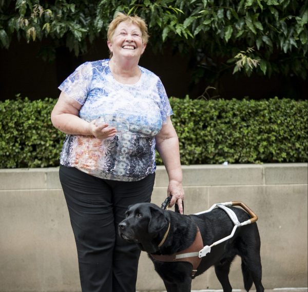 Bionic eye participant Colleen with her seeing eye dog