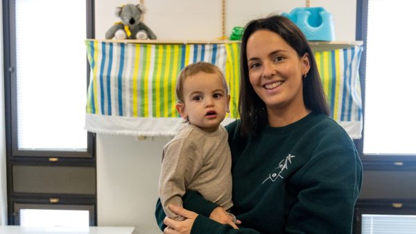 Baby Knox held by mum Shanie smiling at the camera