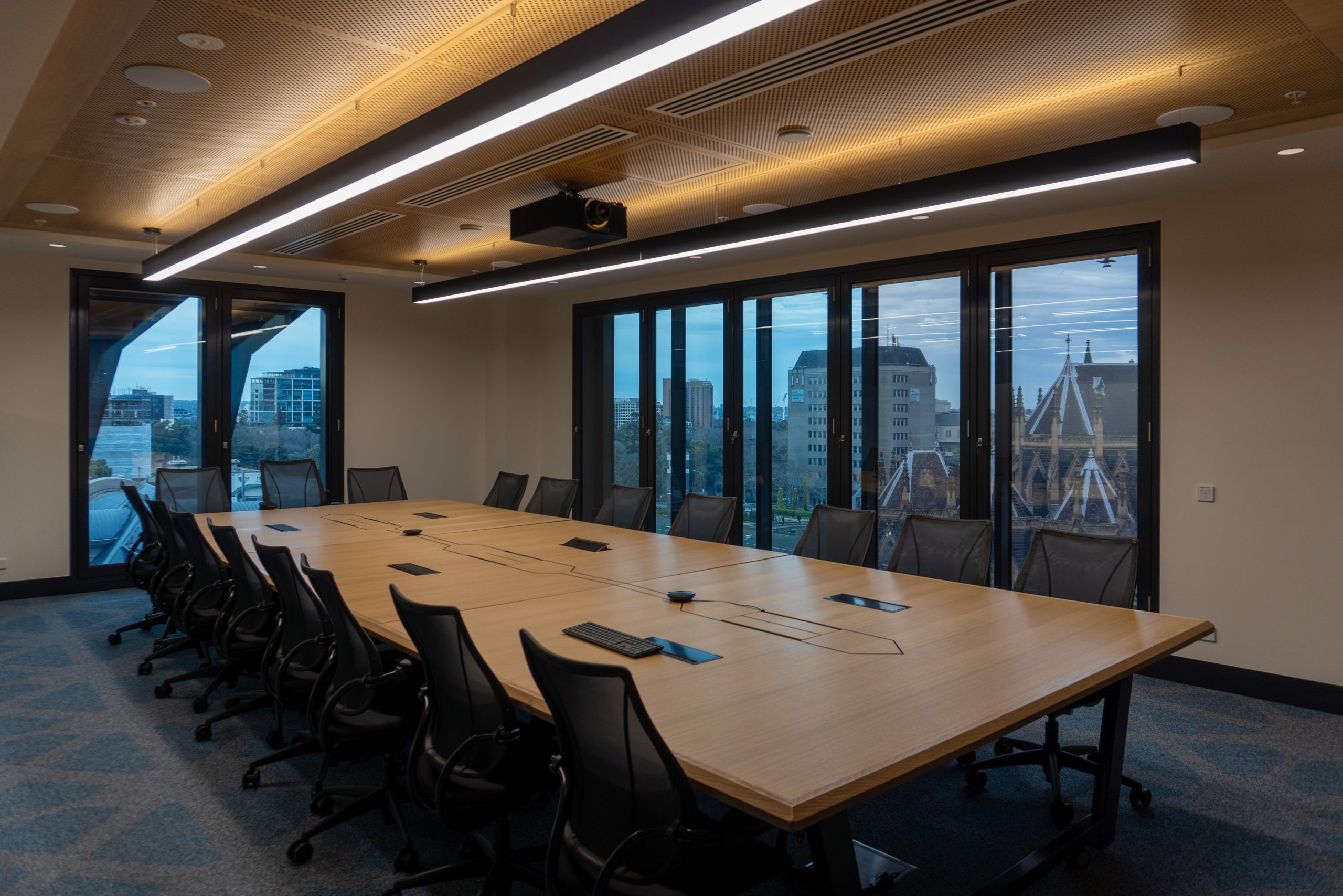 image of Boardroom table and chairs with St Patricks Cathedral in the large windows behind.