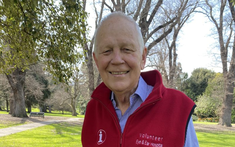 Volunteer Peter Rushen wearing his red volunteering vest