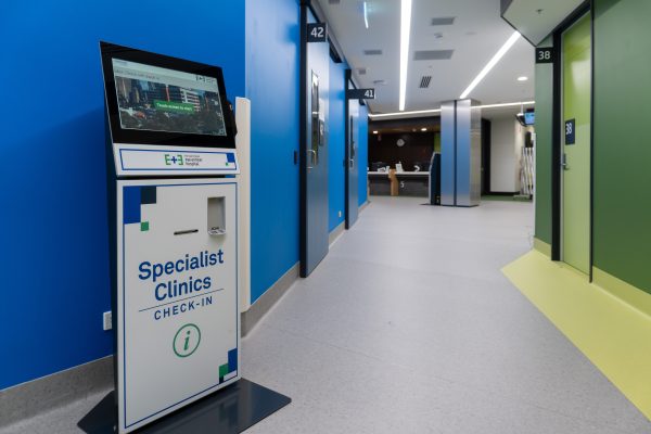 Image of a corridor in specialist clinics featuring one of our patient self check in kiosks.