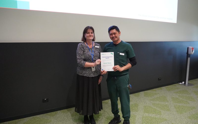 Executive Director Operations and Chief Nursing Officer, Leanne Turner, standing next to nurse Xavier Reyes, holding a certificate.