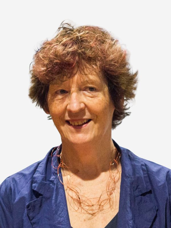 Chris McLoughlin where a blue top and smiling against a white background.