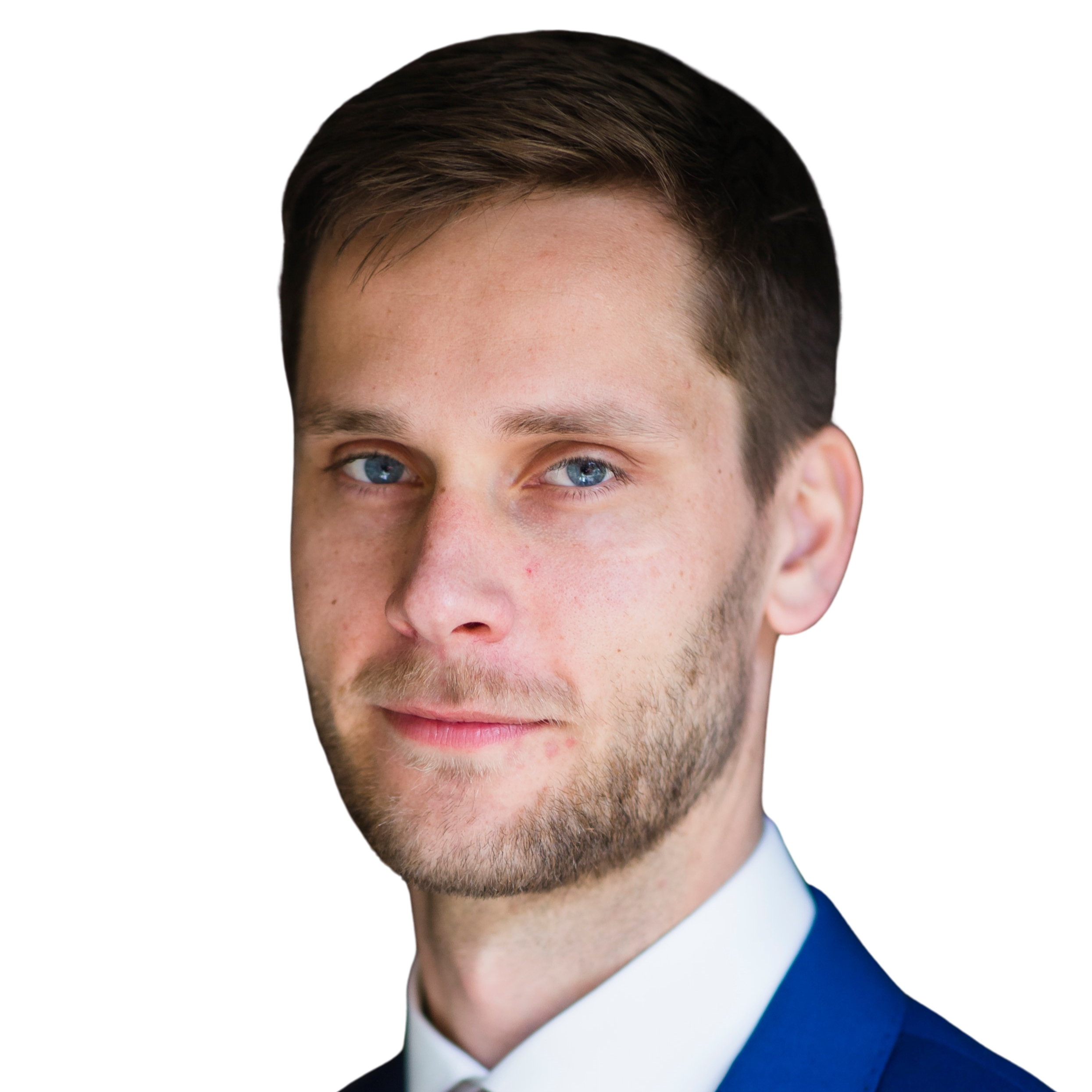 A headshot of a man with short brown hair, wearing a blue suit jacket, white shirt and red tie.