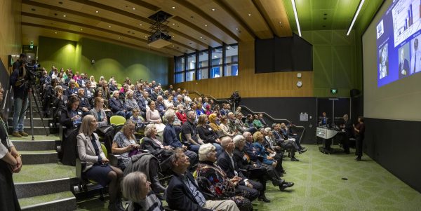 An auditorium full of people celebrating 40 years of cochlear milestones.