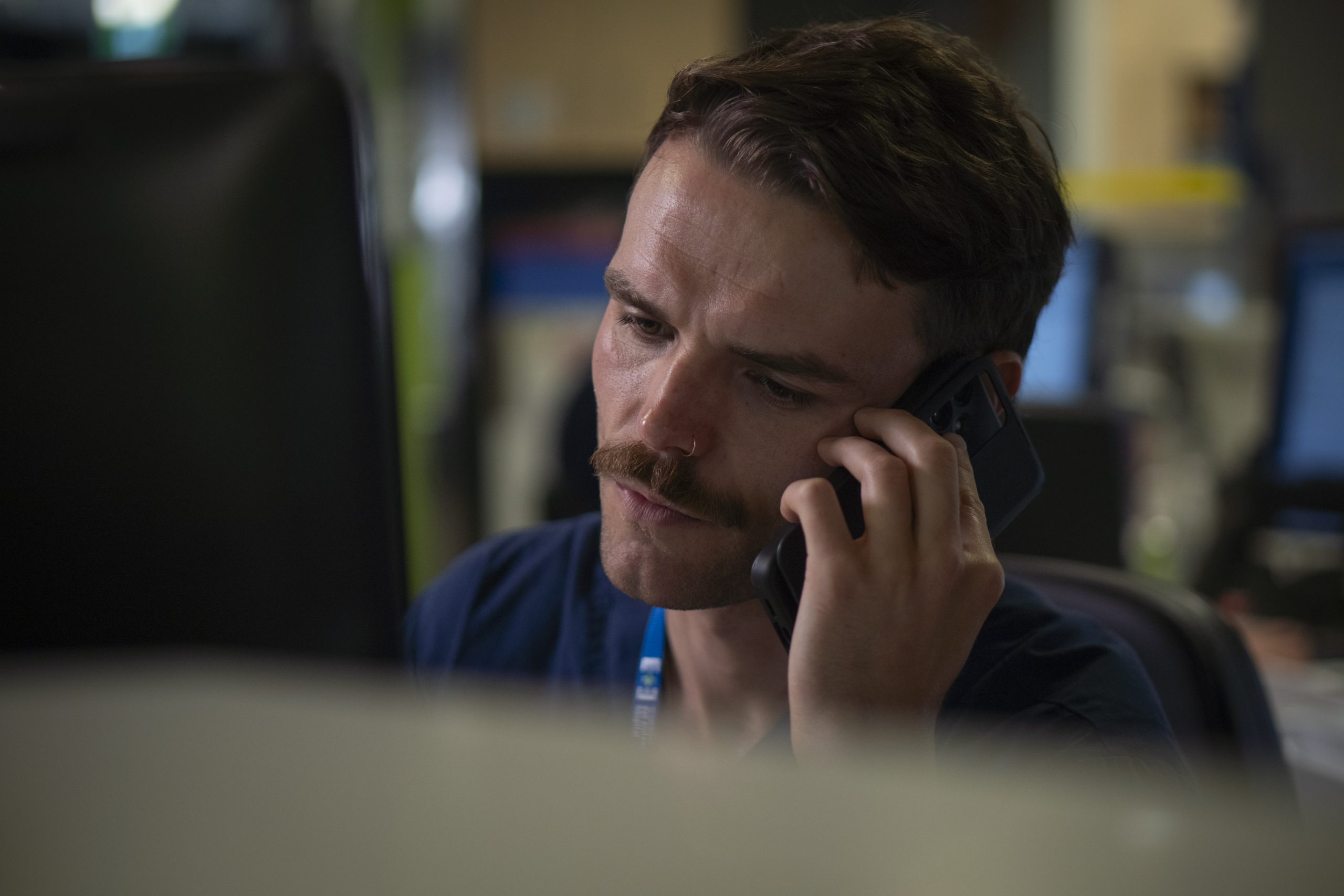 A doctor on a mobile talking to someone.