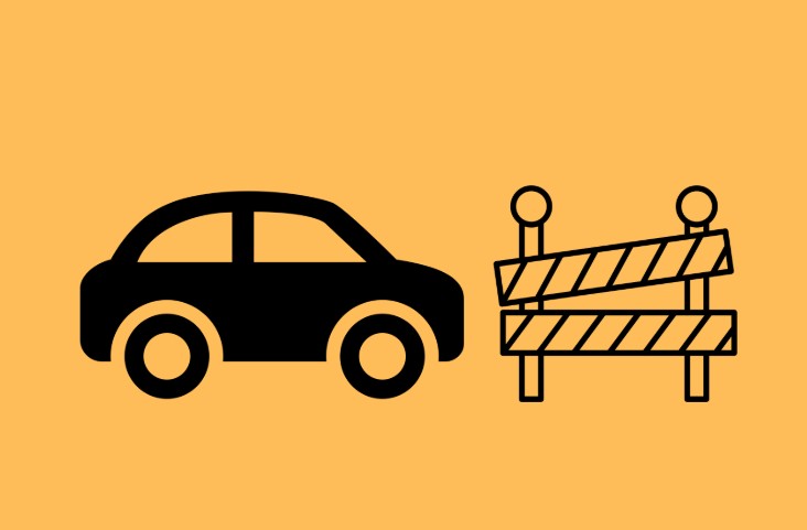 An orange tile with a black car and a barricade in its centre.