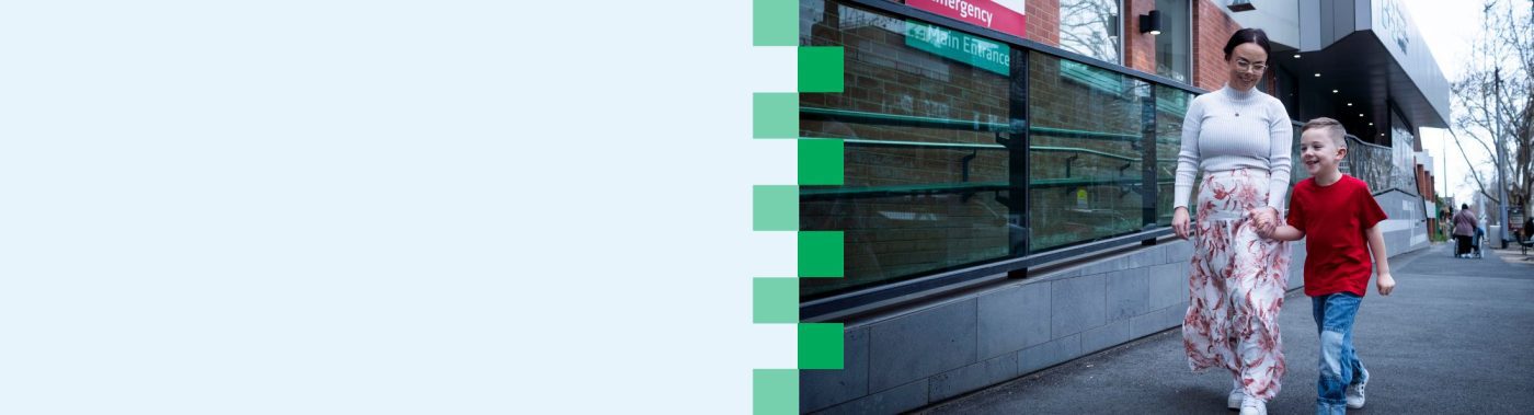 A light blue tile connected to a photo of a woman and a young child as they walk on the street outside the Eye and Ear with smiles on their faces.