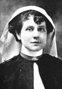 A black an white photo of Bessie McPhail in her nursing uniform with her cap and.