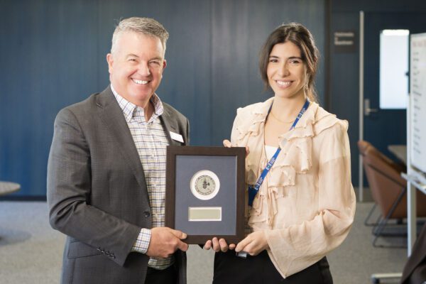 Noel and Imelda Foster awardee Dr Sandra Banderas Garcia holds an award plaque with Chief Executive Officer Brendon Gardner