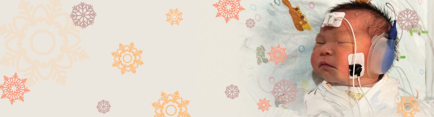 Cream banner with pastel snowflakes and a photo of a baby connected to medical devices sits to the right hand side